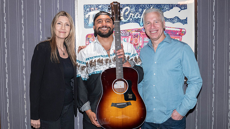 BMI’s Sam Cox, BMI writer Nevin Sastry and BMI’s Mike Steinberg pose with a gifted Taylor guitar at BMI’s #1 Party for A Bar Song (Tipsy) at Craig’s in Los Angeles, CA on May 12, 2025.